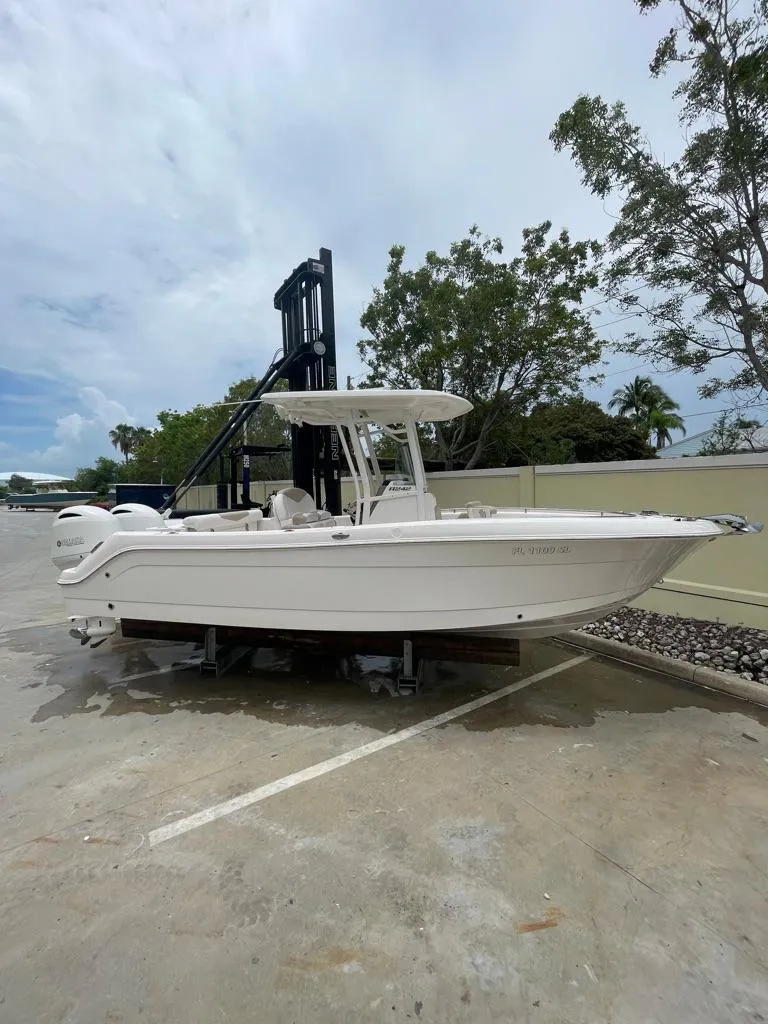 Slide: The Image of 2019 Robalo R242 Center Console boat on a lift, side view. - 3