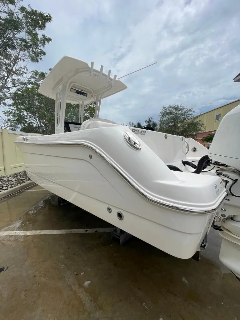 Slide: The Image of 2019 Robalo R242 Center Console boat in a parking lot. - 4