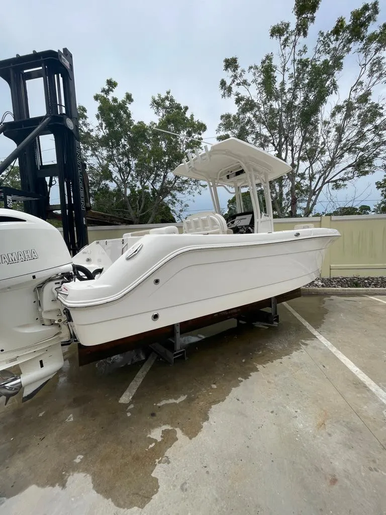 Slide: The Image of 2019 Robalo R242 Center Console boat on a trailer in a parking lot. - 5