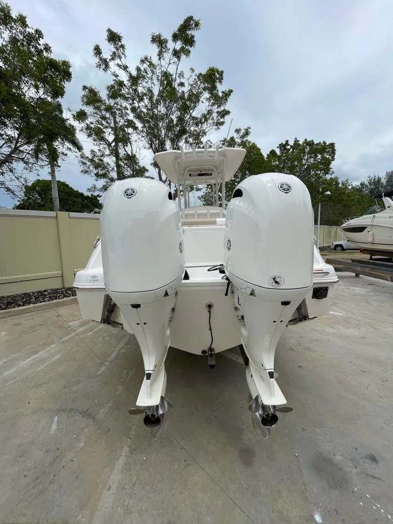 Slide: The Image of 2019 Robalo R242 Center Console boat with twin outboard engines. - 6