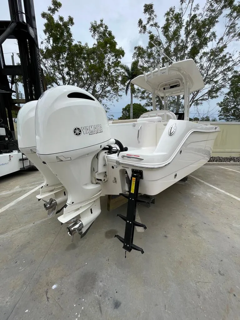 Slide: The Image of 2019 Robalo R242 Center Console boat with twin Yamaha outboard engines. - 7
