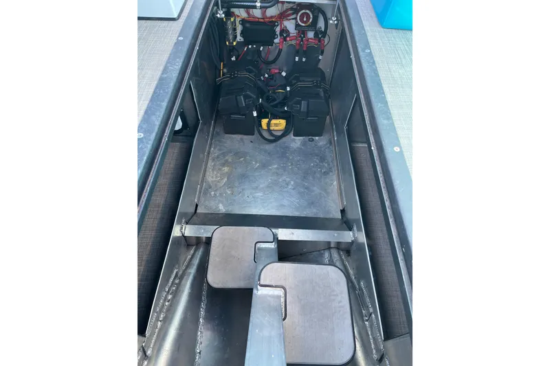 Slide: The Image of 2023 Montara 25 Surf Boss 2.0 CW engine compartment with visible wiring and components. - 11