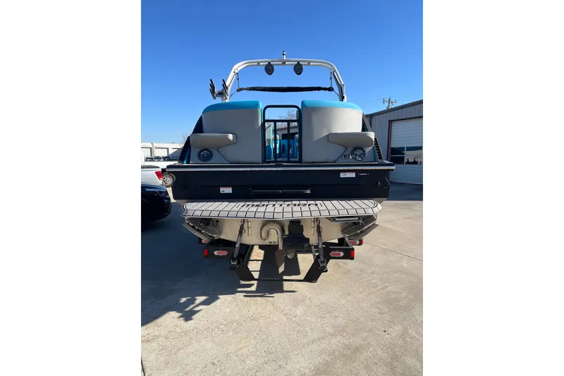 Slide: The Image of 2023 Montara 25 Surf Boss 2.0 CW boat, rear view, parked outdoors. - 4