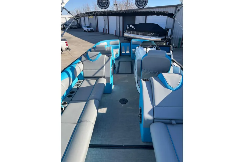 Slide: The Image of 2023 Montara 25 Surf Boss 2.0 CW boat interior with blue and gray seating. - 7