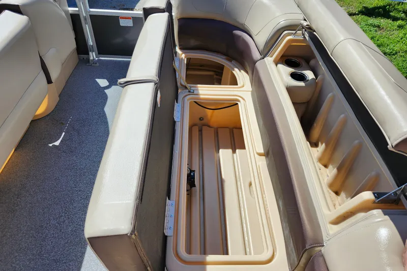Slide: The Image of 2018 Sun Tracker Party Barge 20 DLX interior storage compartments and seating area. - 14