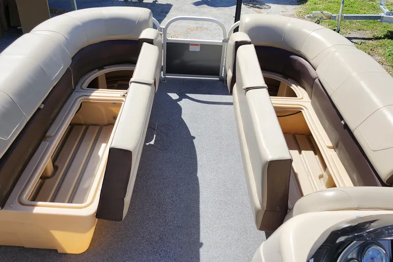 Slide: The Image of 2018 Sun Tracker Party Barge 20 DLX interior with open storage compartments. - 15