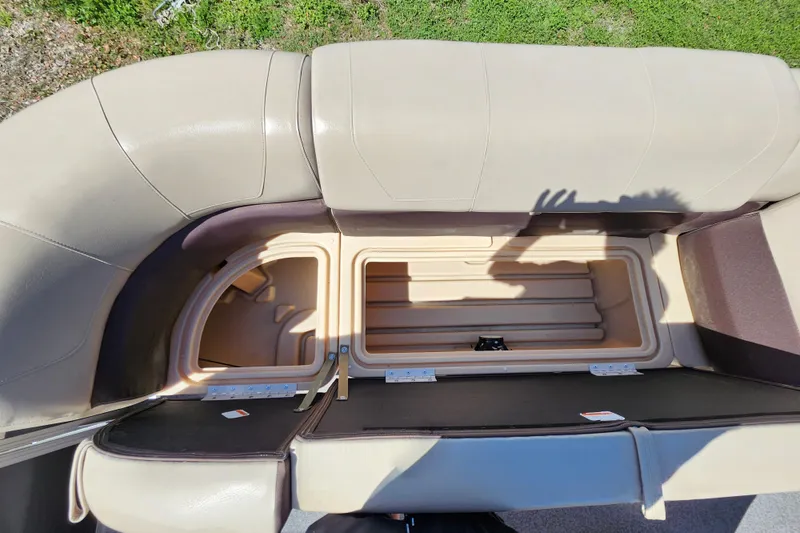 Slide: The Image of 2018 Sun Tracker Party Barge 20 DLX storage compartment with open seating and shadow. - 17