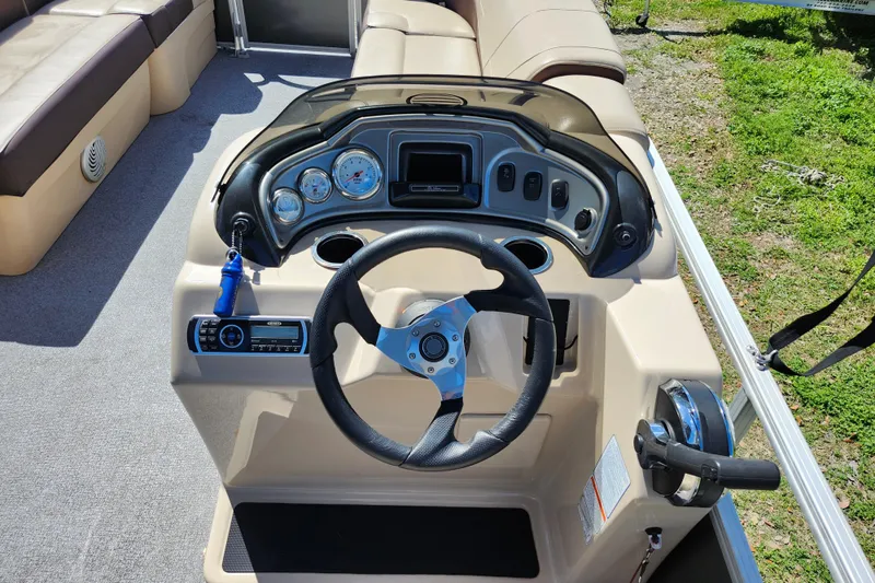 Slide: The Image of 2018 Sun Tracker Party Barge 20 DLX steering console with gauges and controls. - 22