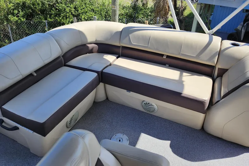 Slide: The Image of 2018 Sun Tracker Party Barge 20 DLX interior with beige seating and spacious layout. - 23