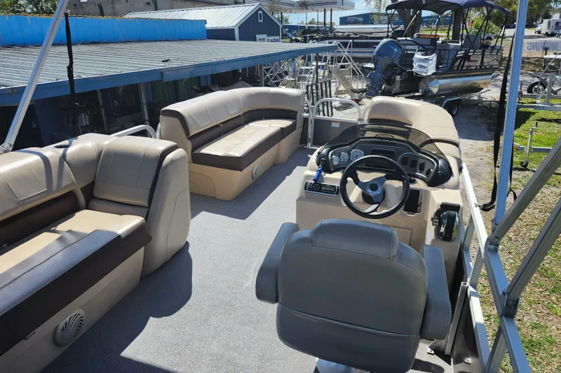 Slide: The Image of 2018 Sun Tracker Party Barge 20 DLX interior with seating and steering console. - 30