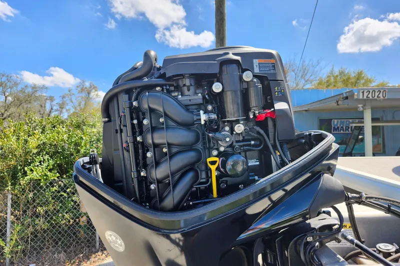 Slide: The Image of Close-up of a 2018 Sun Tracker Party Barge 20 DLX outboard motor under a clear sky. - 7