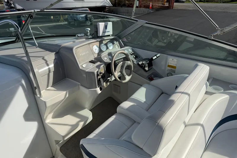 Slide: The Image of Interior of a 2000 Formula boat with white seating and control panel. - 3