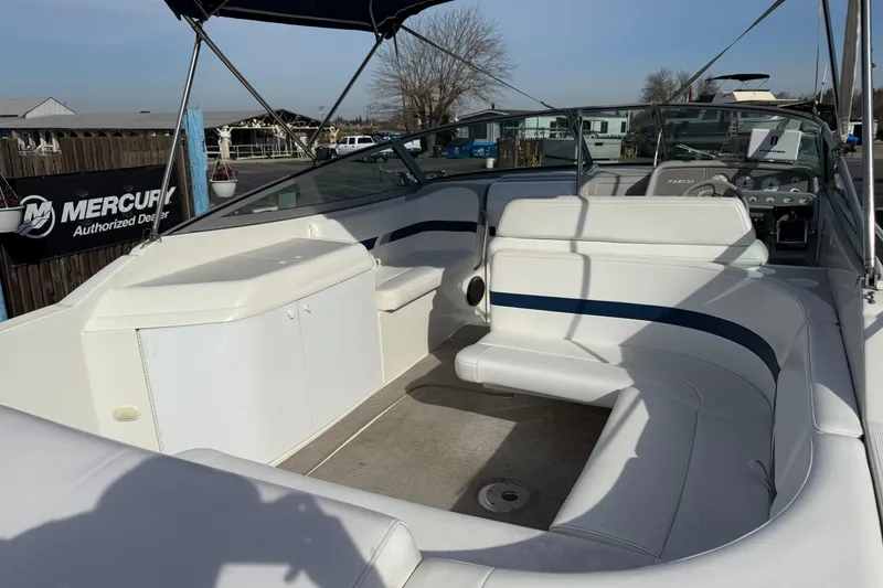 Slide: The Image of 2000 Formula boat interior with white seating and dashboard, located at a Mercury dealer. - 4