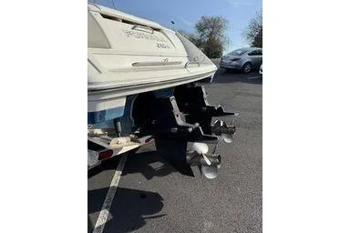 Slide: The Image of Rear view of a 2000 Formula boat with dual propellers in a parking lot. - 7