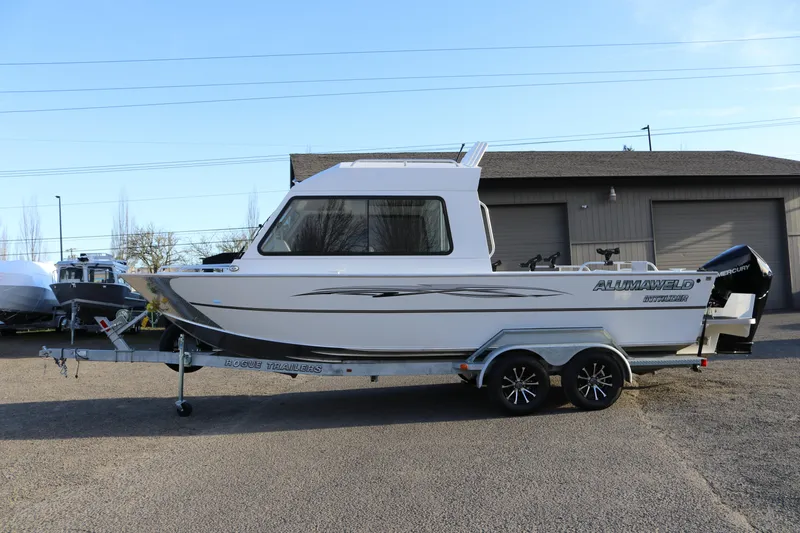 The Image of 2026 Alumaweld Intruder Outboard 22 boat on trailer, parked outdoors. - 1
