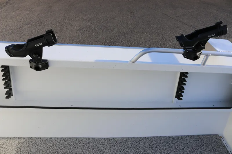Slide: The Image of 2026 Alumaweld Intruder Outboard 22 boat with mounted rod holders on deck. - 11