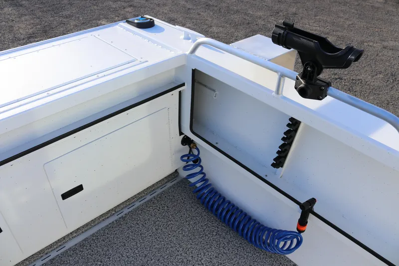 Slide: The Image of 2026 Alumaweld Intruder Outboard 22 boat interior with rod holder and coiled hose. - 13