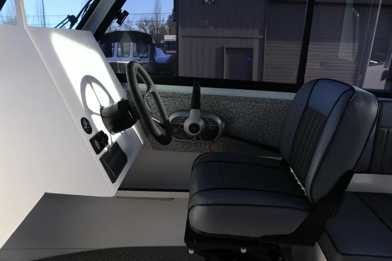 Slide: The Image of 2026 Alumaweld Intruder Outboard 22 interior with steering wheel and seat. - 17