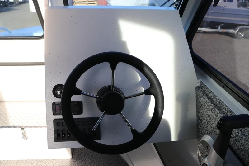 Slide: The Image of Steering wheel and controls of 2026 Alumaweld Intruder Outboard 22 boat. - 18