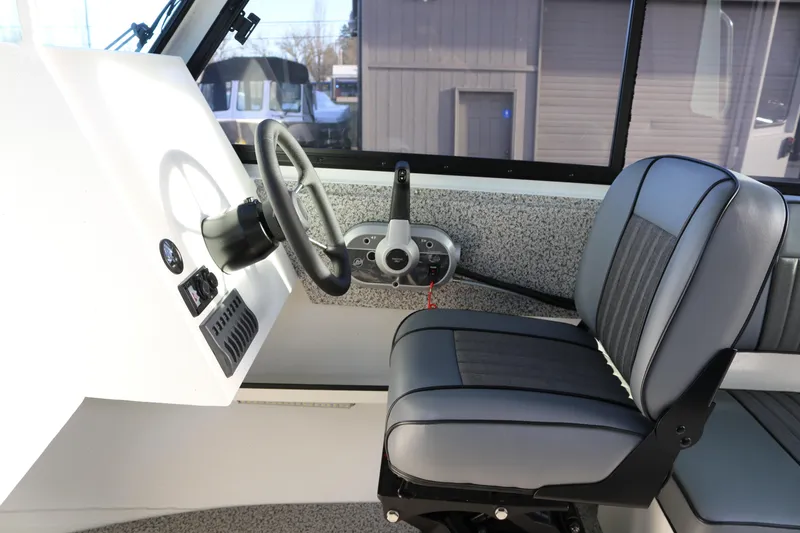 Slide: The Image of 2026 Alumaweld Intruder Outboard 22 interior with steering wheel and seat. - 20