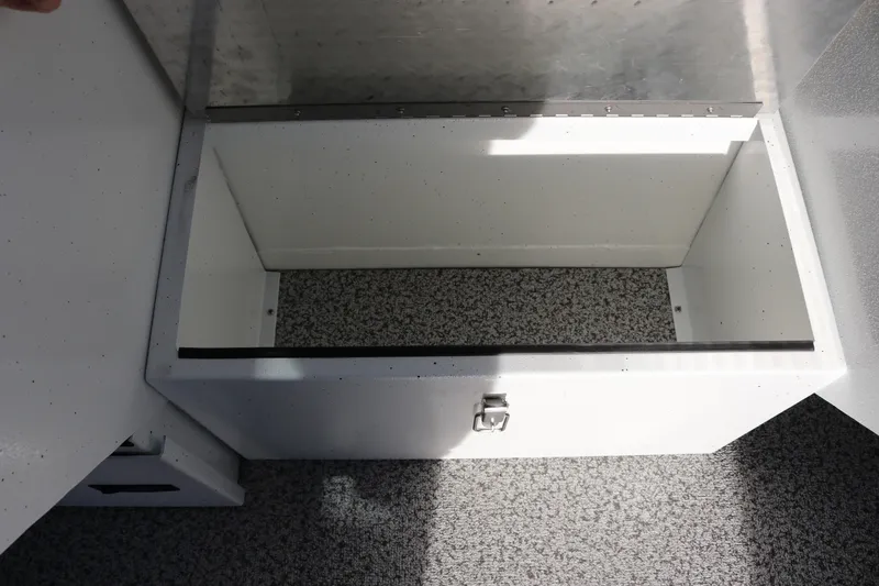 Slide: The Image of Storage compartment in 2026 Alumaweld Intruder Outboard 22 boat, featuring a secure latch. - 23