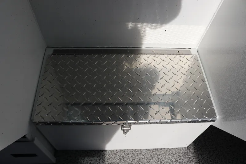 Slide: The Image of Alumaweld Intruder Outboard 22 (2026) diamond plate storage compartment. - 24