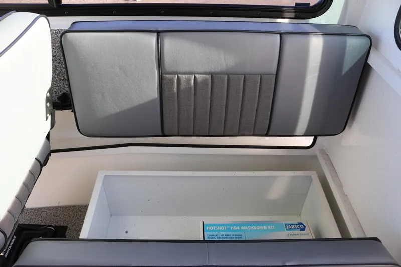 Slide: The Image of 2026 Alumaweld Intruder Outboard 22 interior with storage compartment and washdown kit. - 26