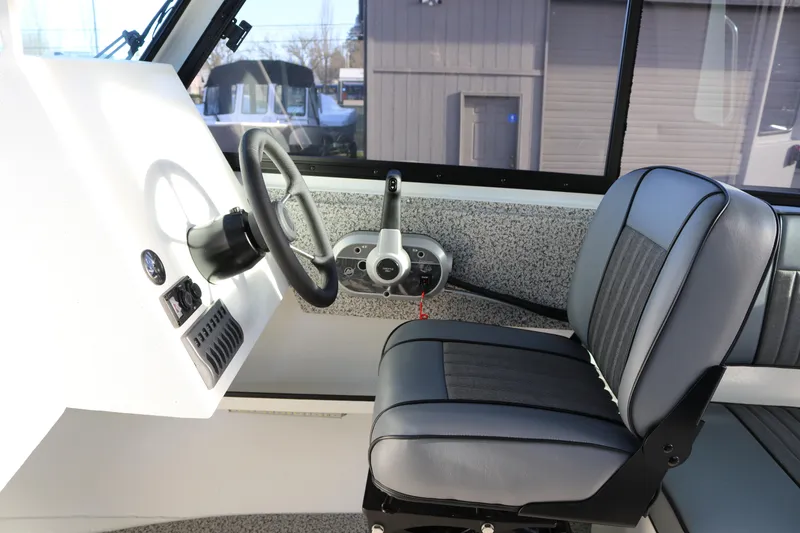 Slide: The Image of 2026 Alumaweld Intruder Outboard 22 boat interior with steering wheel and seat. - 29