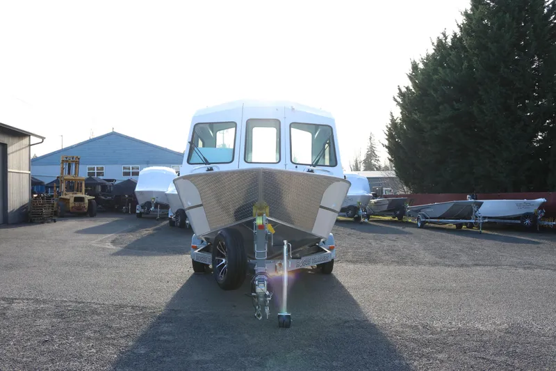 Slide: The Image of 2026 Alumaweld Intruder Outboard 22 boat on trailer in outdoor lot. - 3