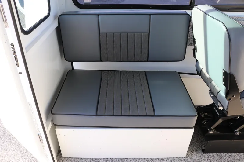 Slide: The Image of 2026 Alumaweld Intruder Outboard 22 interior seating, featuring gray cushioned bench and chair. - 31