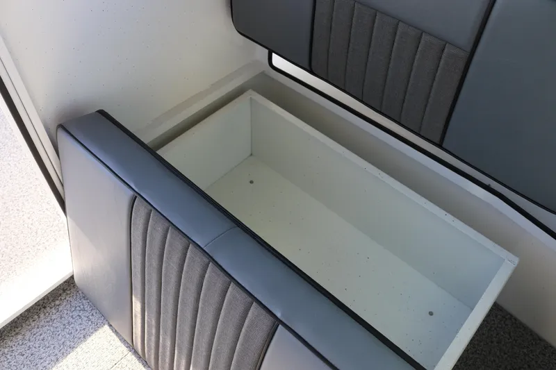 Slide: The Image of 2026 Alumaweld Intruder Outboard 22 interior storage compartment with cushioned seating. - 32