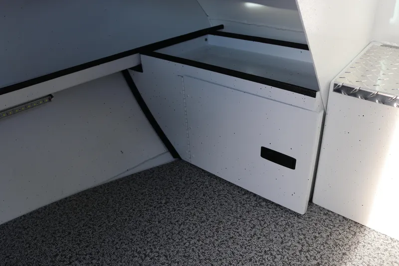 Slide: The Image of Interior of 2026 Alumaweld Intruder Outboard 22 boat, featuring storage compartments. - 34