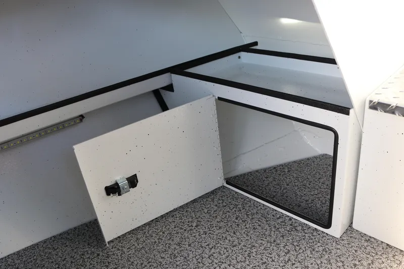 Slide: The Image of 2026 Alumaweld Intruder Outboard 22 interior storage compartment with open hatch. - 35