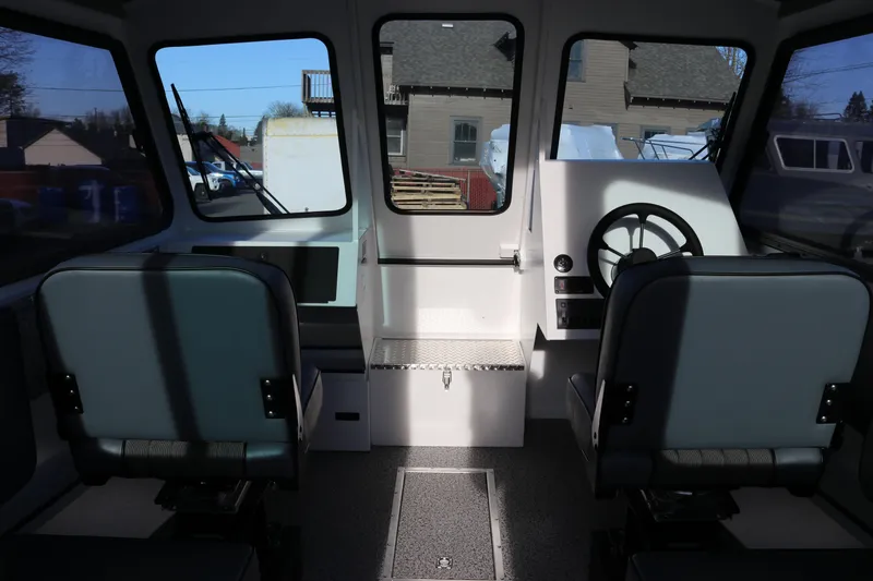 Slide: The Image of Interior of 2026 Alumaweld Intruder Outboard 22 boat, featuring dual seats and steering console. - 36