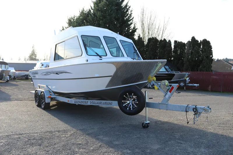 Slide: The Image of 2026 Alumaweld Intruder Outboard 22 boat on trailer, parked outdoors. - 4