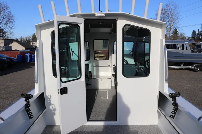 Slide: The Image of 2026 Alumaweld Intruder Outboard 22 boat with open cabin doors, showcasing interior. - 43