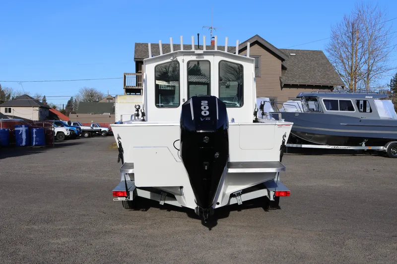 Slide: The Image of 2026 Alumaweld Intruder Outboard 22 boat with 200 V6 engine, parked outdoors. - 44