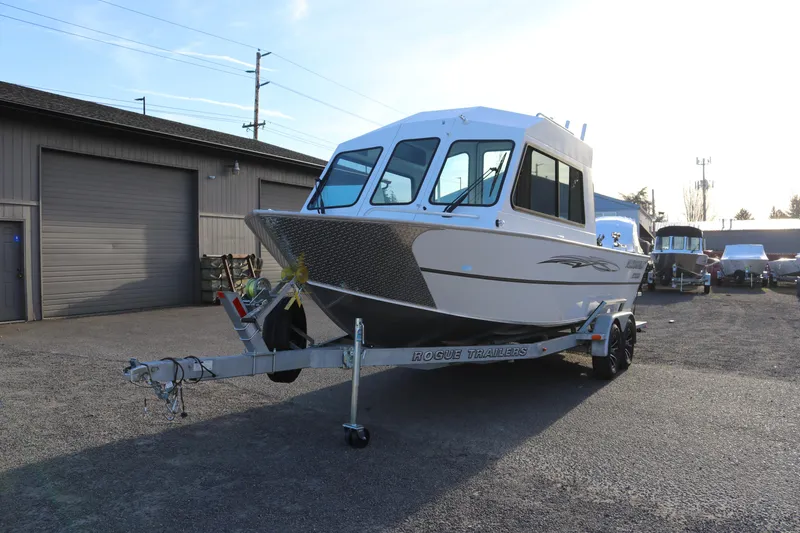Slide: The Image of 2026 Alumaweld Intruder Outboard 22 boat on Rogue trailer in a parking lot. - 5