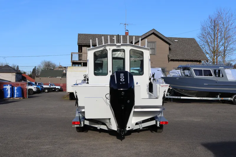 Slide: The Image of 2026 Alumaweld Intruder Outboard 22 boat with 200 V6 engine, parked outdoors. - 6