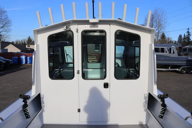 Slide: The Image of 2026 Alumaweld Intruder Outboard 22 boat with enclosed cabin and rod holders. - 7