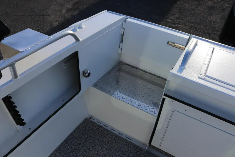 Slide: The Image of 2026 Alumaweld Intruder Outboard 22 boat interior with storage compartments and diamond plate flooring. - 9