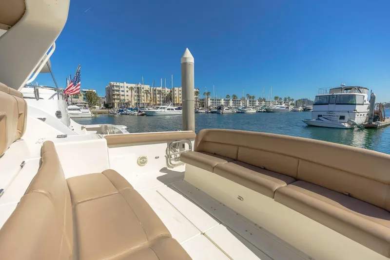 Slide: The Image of Tiara Yachts 4000 Express 2000 model docked in a sunny marina with boats. - 10
