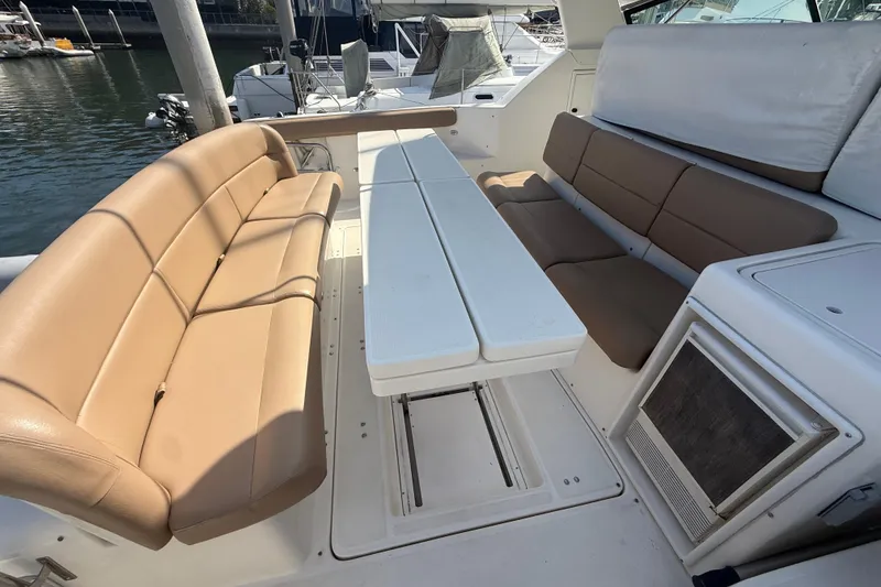 Slide: The Image of Interior seating area of a 2000 Tiara Yachts 4000 Express with beige cushions. - 13