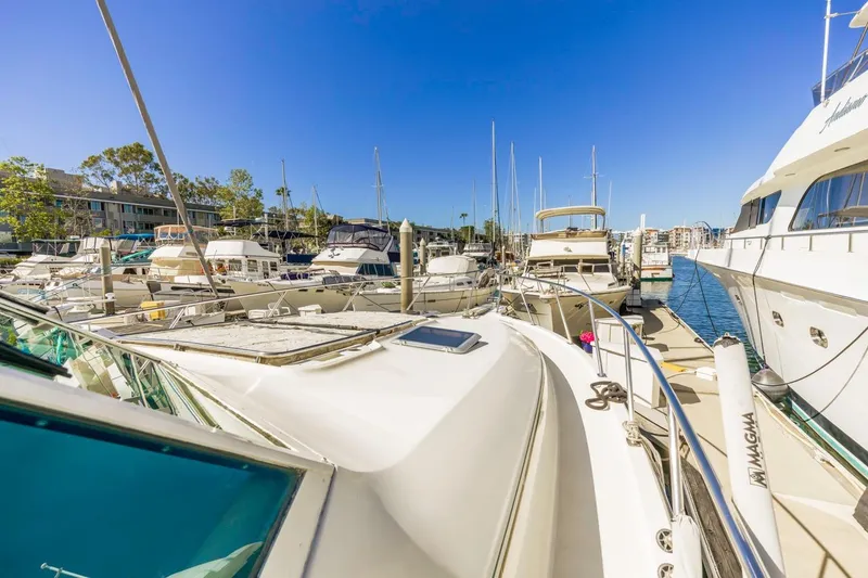 Slide: The Image of Tiara Yachts 4000 Express 2000 model docked in a marina under clear blue skies. - 17