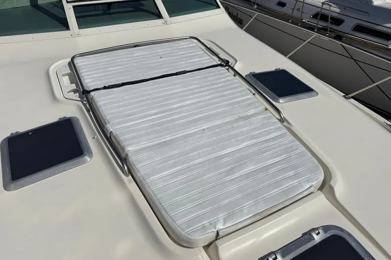 Slide: The Image of Sunpad on 2000 Tiara Yachts 4000 Express deck, featuring sleek design and windows. - 19