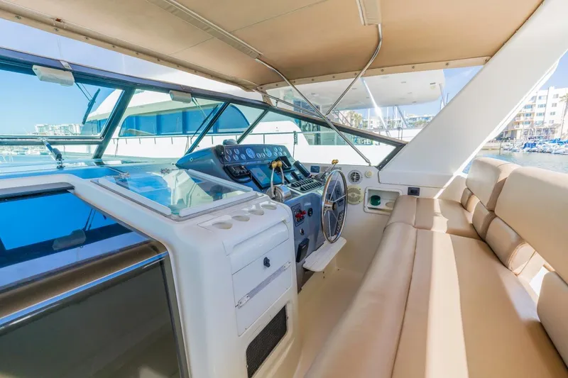 Slide: The Image of Interior view of 2000 Tiara Yachts 4000 Express helm with beige seating and controls. - 21