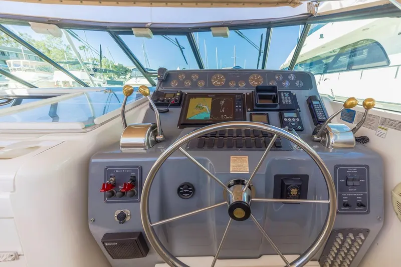 Slide: The Image of Helm of 2000 Tiara Yachts 4000 Express with navigation controls and steering wheel. - 23