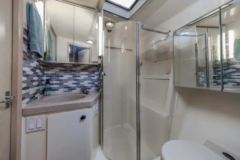 Slide: The Image of Bathroom interior of 2000 Tiara Yachts 4000 Express with modern fixtures and glass shower. - 27