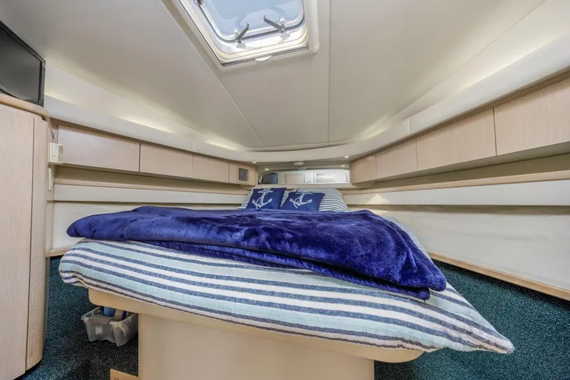 Slide: The Image of Luxurious cabin interior of 2000 Tiara Yachts 4000 Express with cozy bedding and skylight. - 28