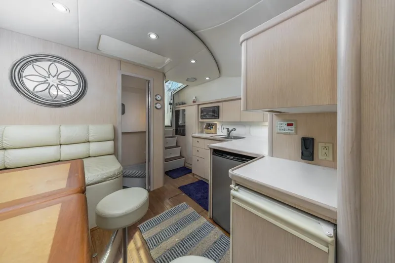 Slide: The Image of Interior of 2000 Tiara Yachts 4000 Express, featuring modern kitchen and seating area. - 29